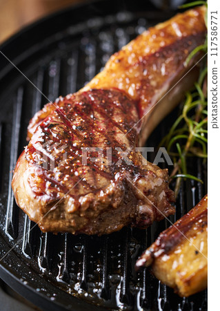 Hokkaido Ezo deer meat grilled on a hot plate Game meat Bone-in loin 117586771