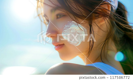Close-up of a Caucasian woman's face applying sunscreen cream Close-up of a Caucasian woman's face applying sunscreen cream 117586772