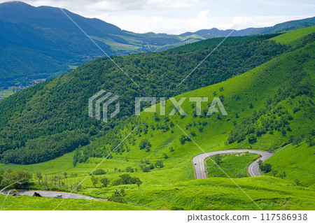 A winding road in the middle of nature 117586938