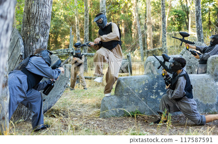 Attack of the paintball team on the enemy at army training ground 117587591