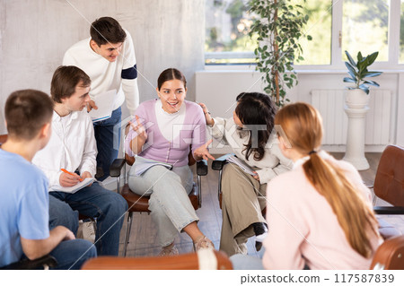 Group of students studying for difficult test in studygroup together 117587839