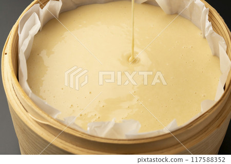 Making steamed bread: pouring ingredients into steamer Making steamed bread: pouring ingredients into steamer 117588352