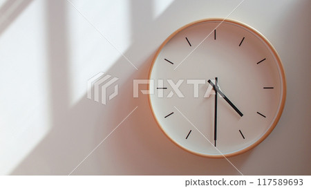 Minimalist Wooden Clock at 16.30/04.30 with Soft Shadows on White Wall - Perfect for Time Management and Lifestyle Branding 117589693