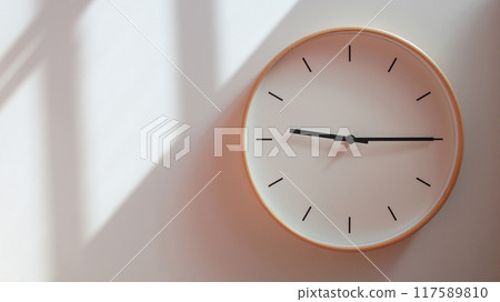 Minimalist Wooden Clock at 21.15/09.15 with Soft Shadows on White Wall - Perfect for Time Management and Lifestyle Branding 117589810