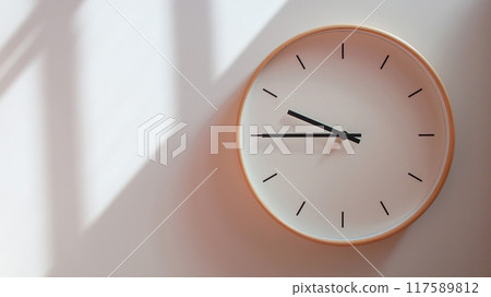 Minimalist Wooden Clock at 21.45/09.45 with Soft Shadows on White Wall - Perfect for Time Management and Lifestyle Branding Minimalist Wooden Clock at 21.45/09.45 with Soft Shadows on White Wall - Perfect for Time Management and Lifestyle Branding 117589812