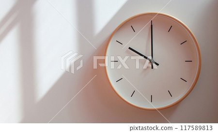 Minimalist Wooden Clock at 10.00/22.00 with Soft Shadows on White Wall - Perfect for Time Management and Lifestyle Branding Minimalist Wooden Clock at 10.00/22.00 with Soft Shadows on White Wall - Perfect for Time Management and Lifestyle Branding 117589813