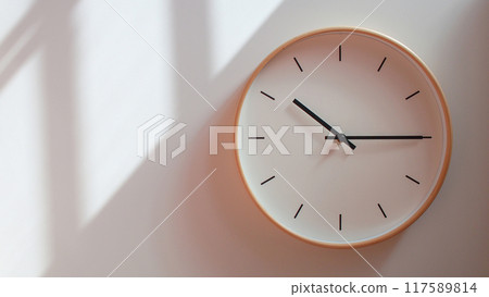 Minimalist Wooden Clock at 22.15/10.15 with Soft Shadows on White Wall - Perfect for Time Management and Lifestyle Branding Minimalist Wooden Clock at 22.15/10.15 with Soft Shadows on White Wall - Perfect for Time Management and Lifestyle Branding 117589814