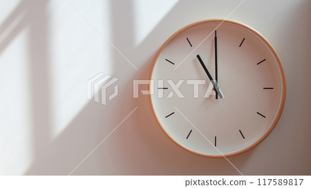 Minimalist Wooden Clock at 23.00/11.00 with Soft Shadows on White Wall - Perfect for Time Management and Lifestyle Branding 117589817