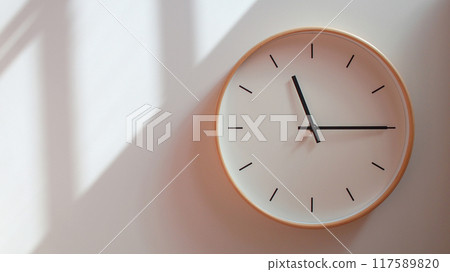 Minimalist Wooden Clock at 23.15/11.15 with Soft Shadows on White Wall - Perfect for Time Management and Lifestyle Branding 117589820