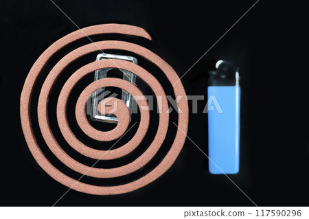 A blue lighter sits next to a mosquito coils 117590296