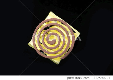 A yellow piece of paper with a mosquito coils on it 117590297