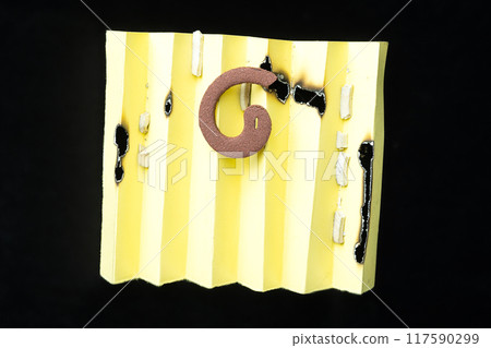 A yellow piece of paper with a mosquito coils on it A yellow piece of paper with a mosquito coils on it 117590299