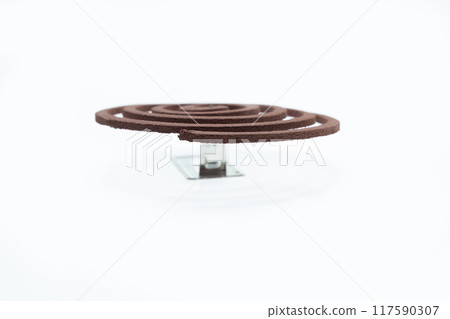 A mosquito coil with smoke coming out of it 117590307