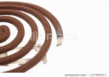 A mosquito coil with smoke coming out of it 117590311