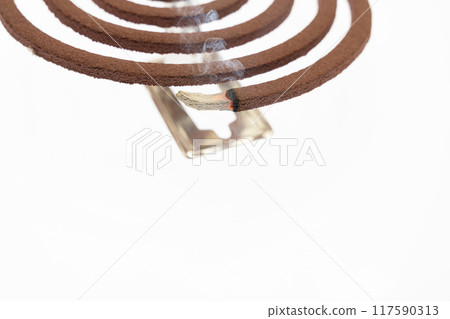 A mosquito coil with smoke coming out of it 117590313