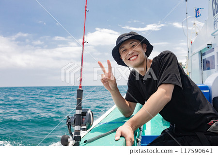 A man enjoying sea fishing A man enjoying sea fishing 117590641