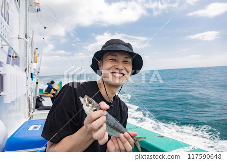 A man enjoying sea fishing A man enjoying sea fishing 117590648