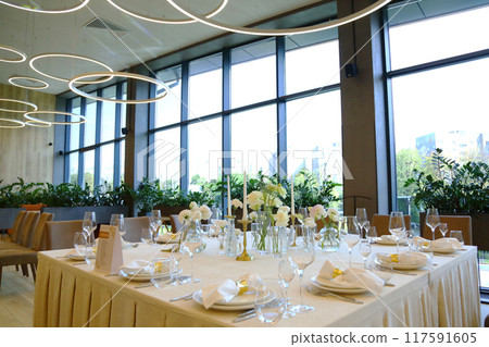 Table setting in a restaurant. Empty glasses set in restaurant. Table setting with glasses, cutlery and plates. Restaurant interior. Table setting in a restaurant. Empty glasses set in restaurant. Table setting with glasses, cutlery and plates. Restaurant interior. 117591605