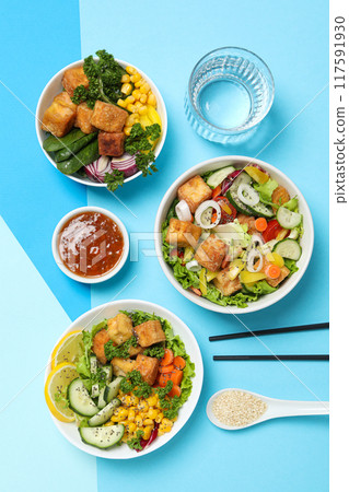 Fried tofu salad with fresh vegetables and sauce 117591930