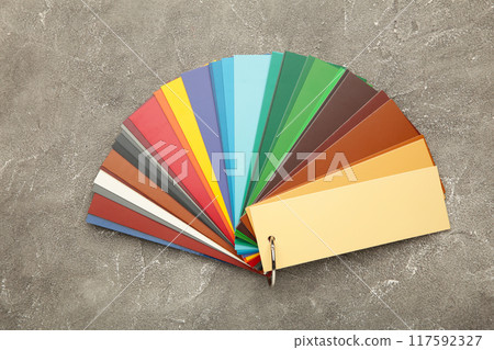 Colored cardboard palette, paper catalog on a grey concrete background. Colored cardboard palette, paper catalog on a grey concrete background. 117592327