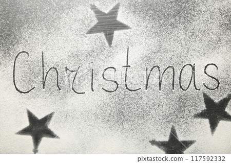Christmas composition. Christmas text made with flour on black background. Christmas composition. Christmas text made with flour on black background. 117592332