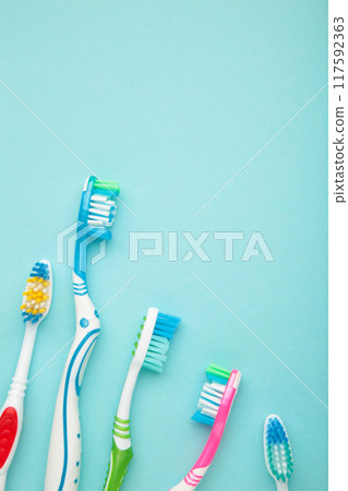 Toothbrushes on blue background with copy space. Vertical foto. Toothbrushes on blue background with copy space. Vertical foto. 117592363