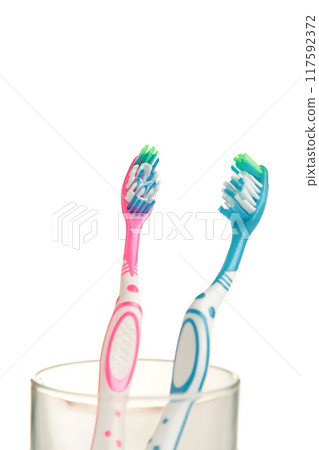 Toothbrushes in glass isolated on white background 117592372