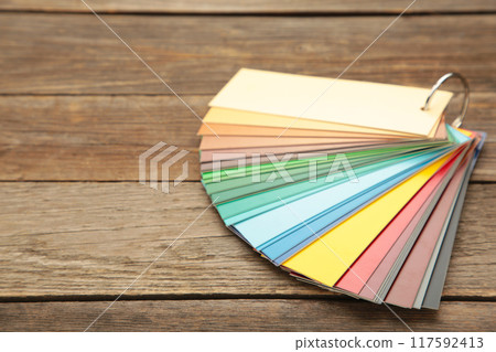 Colored cardboard palette, paper catalog on a grey wooden background. Colored cardboard palette, paper catalog on a grey wooden background. 117592413