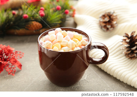 Cup of hot chocolate drink and marshmallow with christmas composition on grey concrete background. 117592548