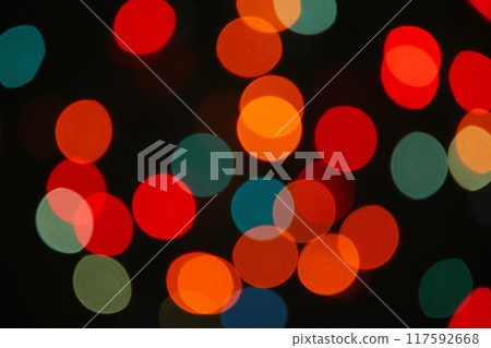 Christmas light background. Holiday glowing backdrop. Defocused Background With Blinking Stars. Blurred Bokeh. 117592668