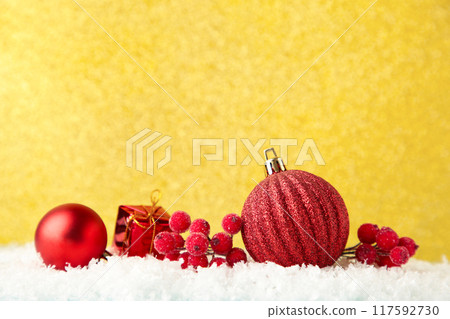 Christmas red decorations on gold glitter background. Christmas red decorations on gold glitter background. 117592730