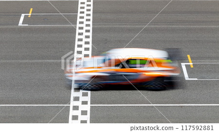Motion blur race car racing on speed track, Car race on the international circuit race track crossing start and finish line, Race car crossing start and finish line, Target business achieve. Motion blur race car racing on speed track, Car race on the international circuit race track crossing start and finish line, Race car crossing start and finish line, Target business achieve. 117592881