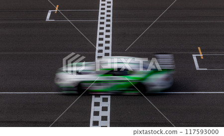 Motion blur race car racing on speed track, Car race on the international circuit race track crossing start and finish line, Race car crossing start and finish line, Target business achieve. 117593000