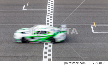 Motion blur race car racing on speed track, Car race on the international circuit race track crossing start and finish line, Race car crossing start and finish line, Target business achieve. 117593035