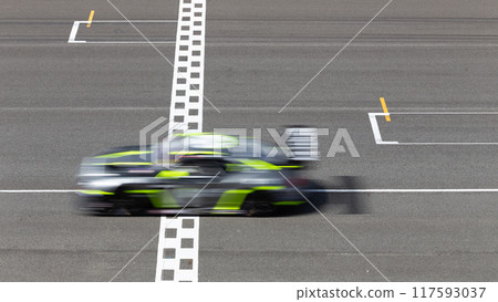 Motion blur race car racing on speed track, Car race on the international circuit race track crossing start and finish line, Race car crossing start and finish line, Target business achieve. 117593037
