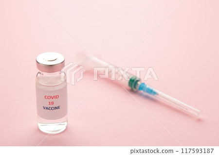 Coronavirus COVID-19 vaccine vials and syringe on pink background. Coronavirus COVID-19 vaccine vials and syringe on pink background. 117593187
