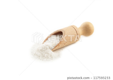 Regular table salt in a wooden spoon isolated on white background Regular table salt in a wooden spoon isolated on white background 117593233