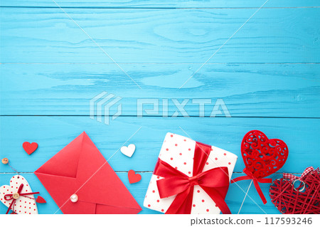 Valentine's day card. Composition with gifts, red hearts and rose on blue. Valentine's day card. Composition with gifts, red hearts and rose on blue. 117593246