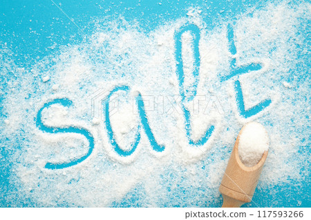 Sea salt with the inscription SALT on blue background. Spa treatments. Sea salt with the inscription SALT on blue background. Spa treatments. 117593266