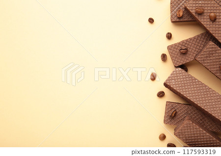 Chocolate wafers with coffee on beige background Chocolate wafers with coffee on beige background 117593319