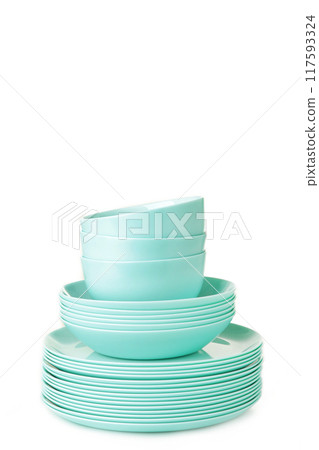 Stacks of mint ceramic dishware isolated on white background 117593324