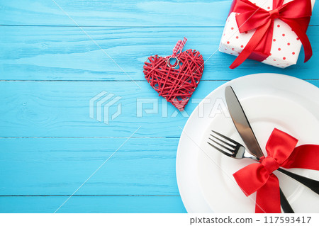 Festive table setting for Valentines Day on blue wooden background. 117593417
