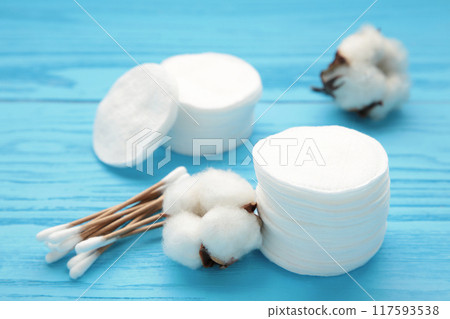 Cotton swabs and sticks with flower on blue background 117593538