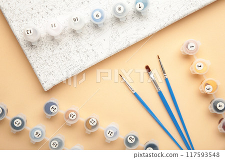 Paints for drawing pictures by numbers on beige Paints for drawing pictures by numbers on beige 117593548