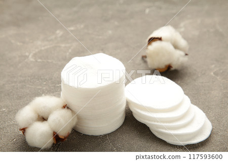 Hygienic disposable product cosmetic pads and cotton flower on grey background 117593600
