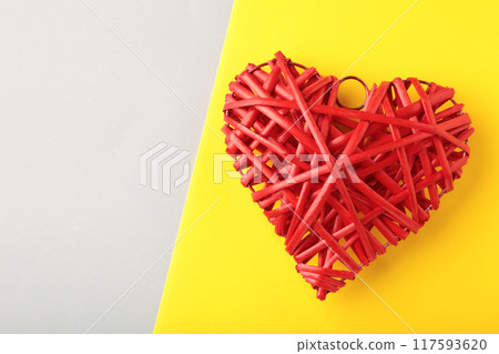 Rustic red wooden heart on grey and yellow background. Rustic red wooden heart on grey and yellow background. 117593620