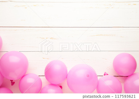Pink pastel party balloons on white wooden background with copy space for text. Pink pastel party balloons on white wooden background with copy space for text. 117593621