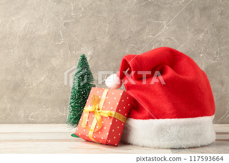 Christmas gift with santa hat on grey background 117593664