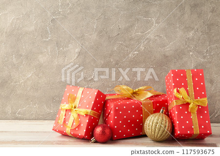 Christmas gift box with decoration on grey concrete background. 117593675