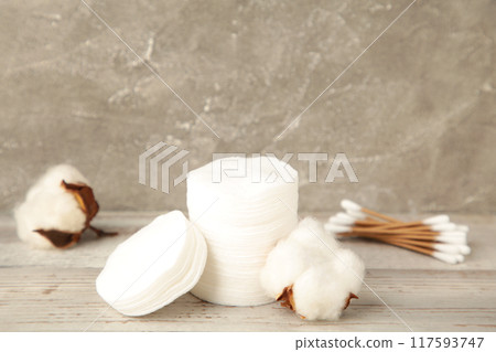 Hygienic disposable product cosmetic pads and cotton flower on grey background Hygienic disposable product cosmetic pads and cotton flower on grey background 117593747